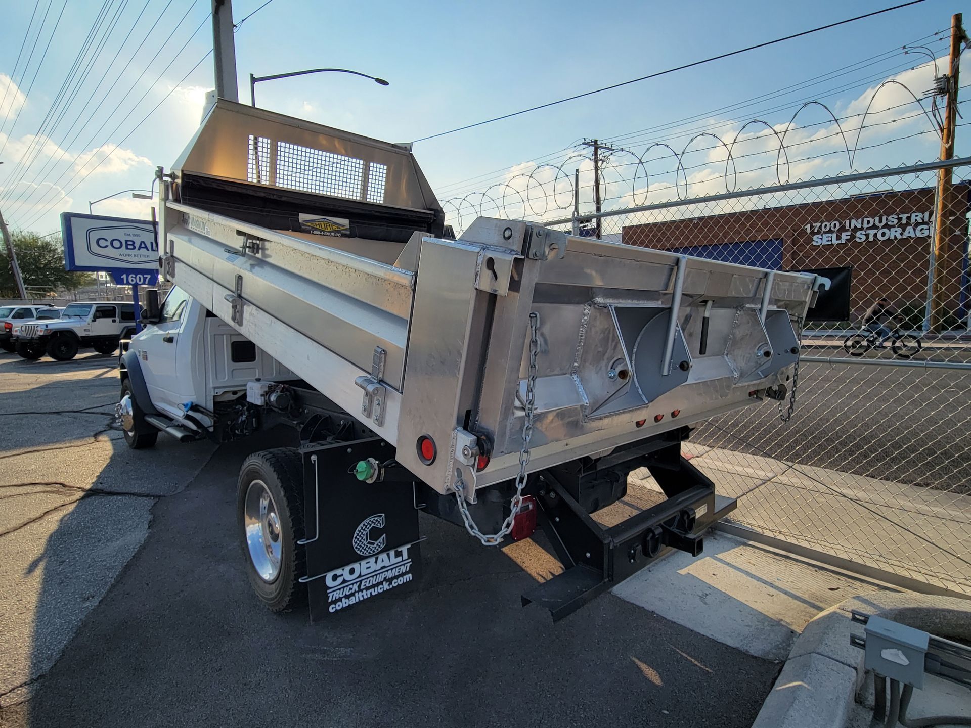 A dump truck is parked on the side of the road.