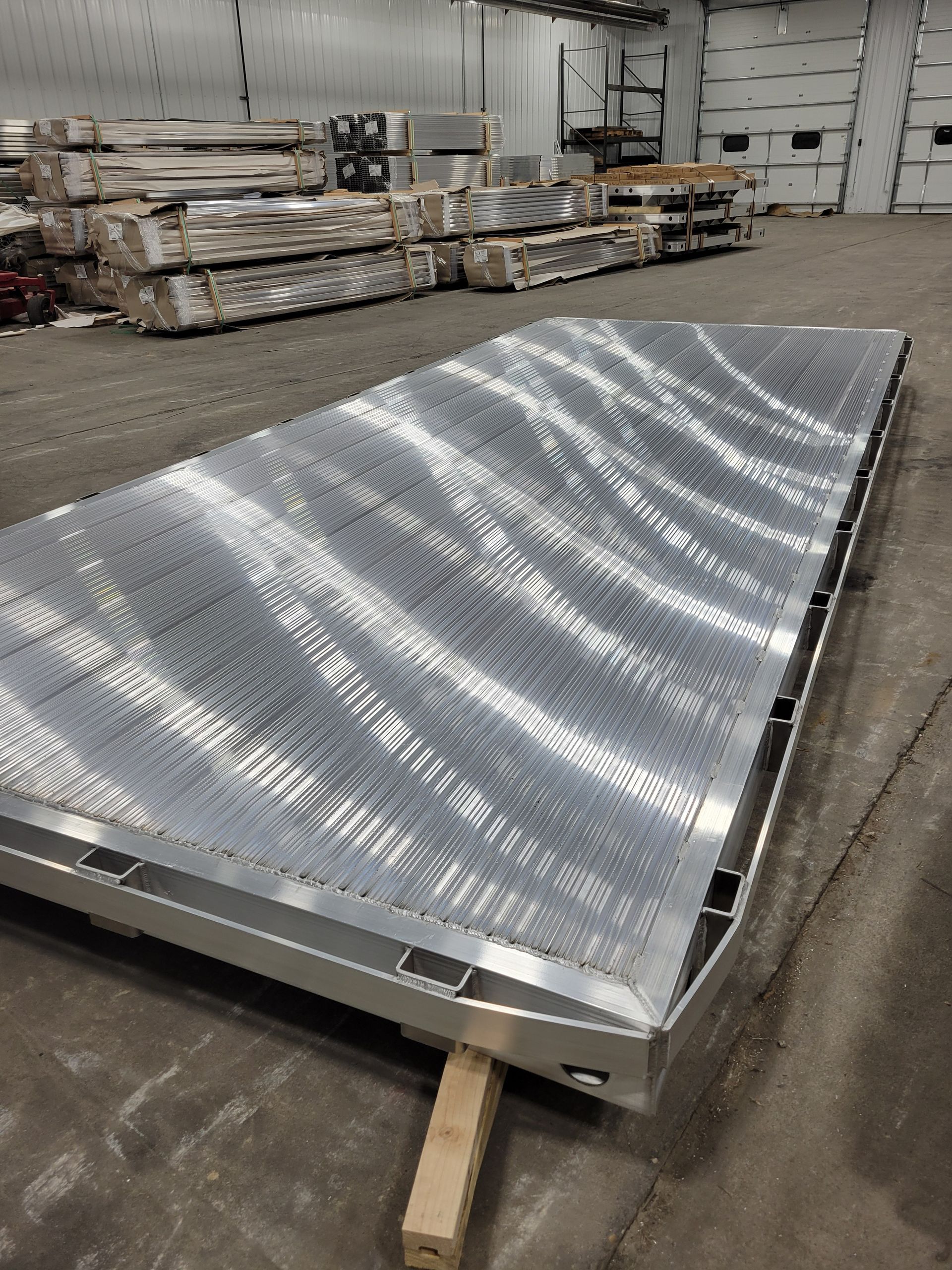 A large piece of metal is sitting on the ground in a warehouse.