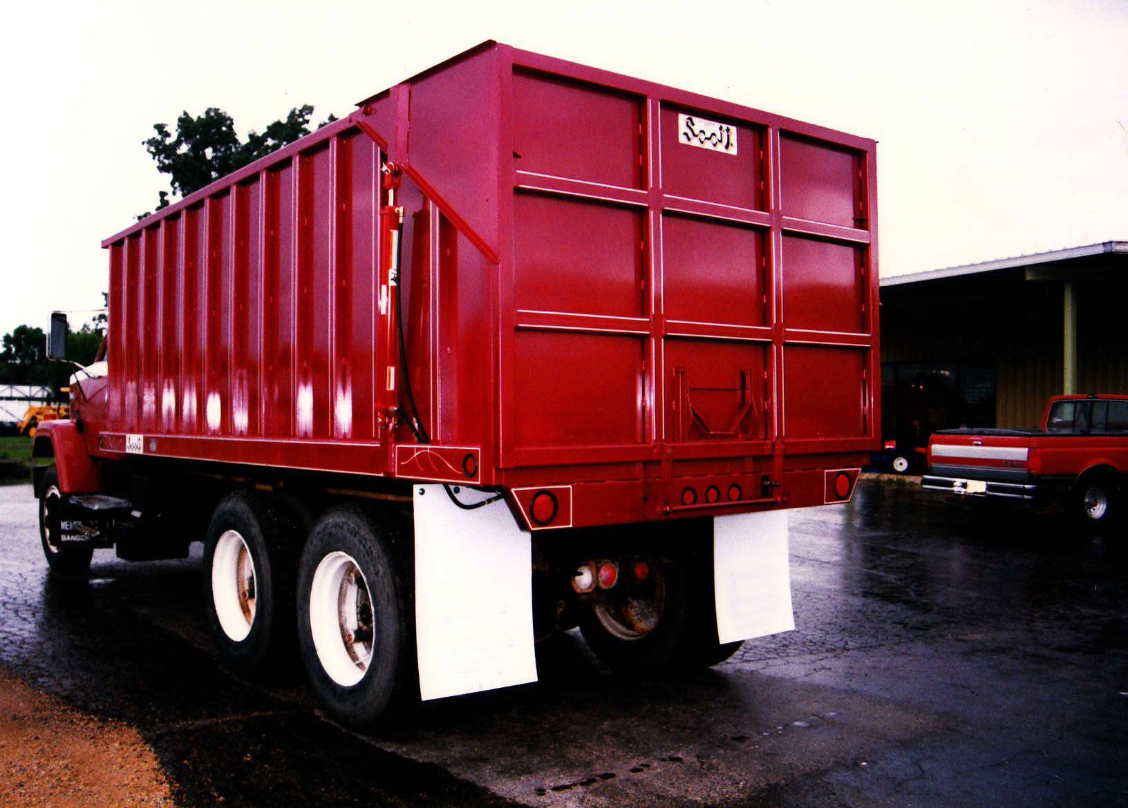 A red dump truck with the number 5201 on the back