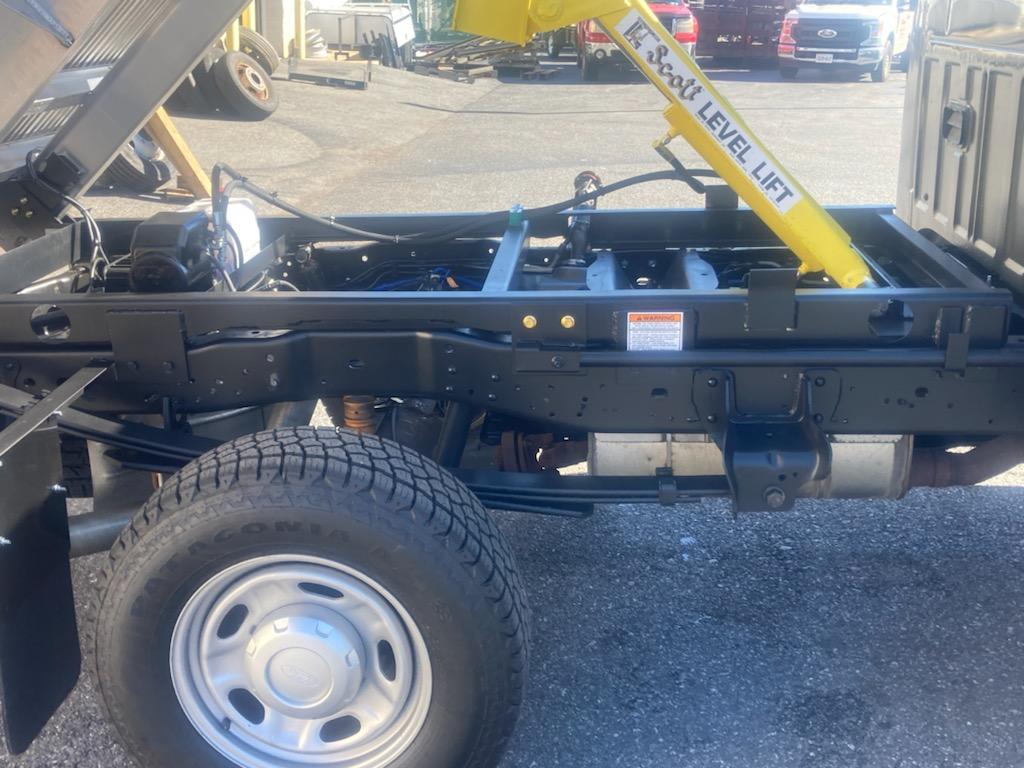 A dump truck with a level lift attached to it