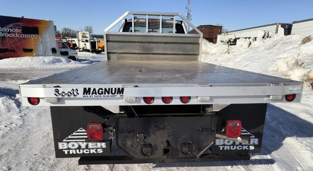 A flatbed truck with the word magnum on the back