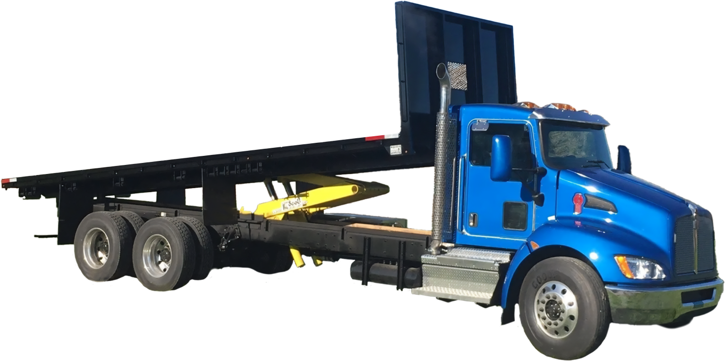 A blue semi truck with a flatbed trailer attached to it.