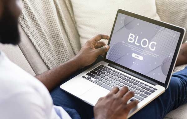 man on computer writing a blog