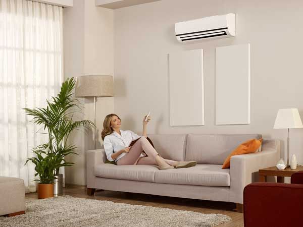 woman on couch with air conditioning unit