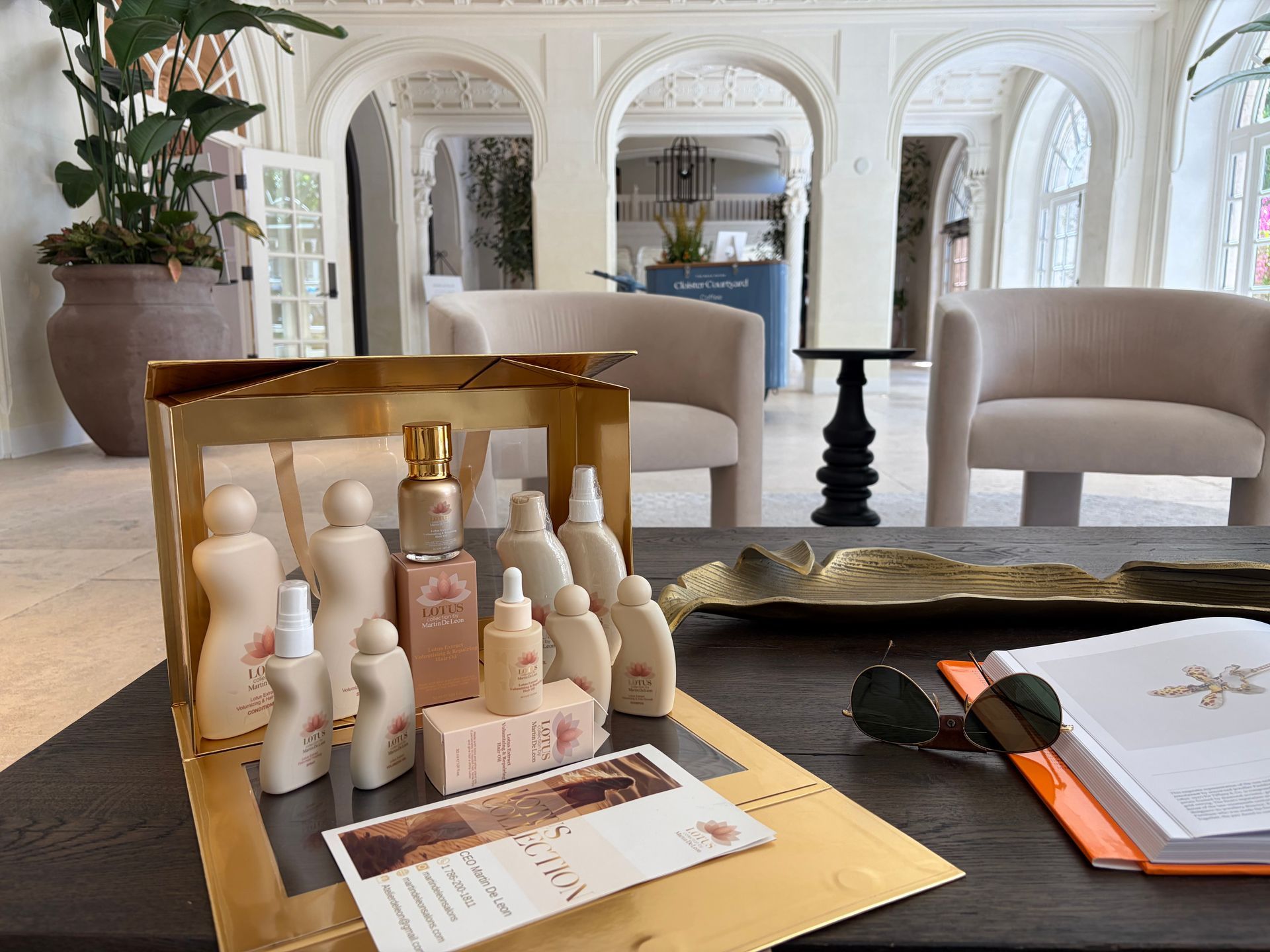 Bright, airy hair salon interior with white and gold accents, multiple styling stations.