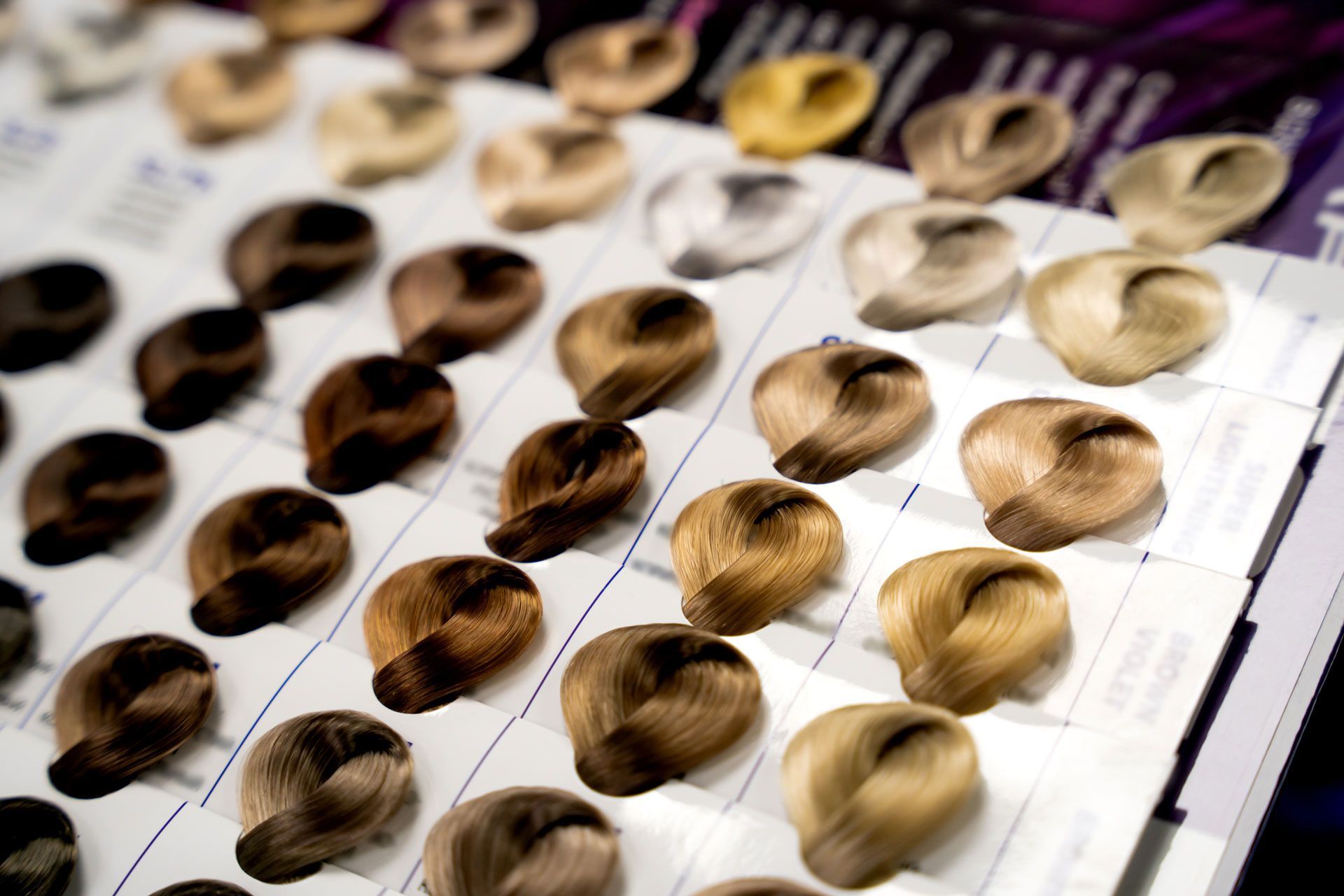 Hair color swatches in various shades arranged on a display card.