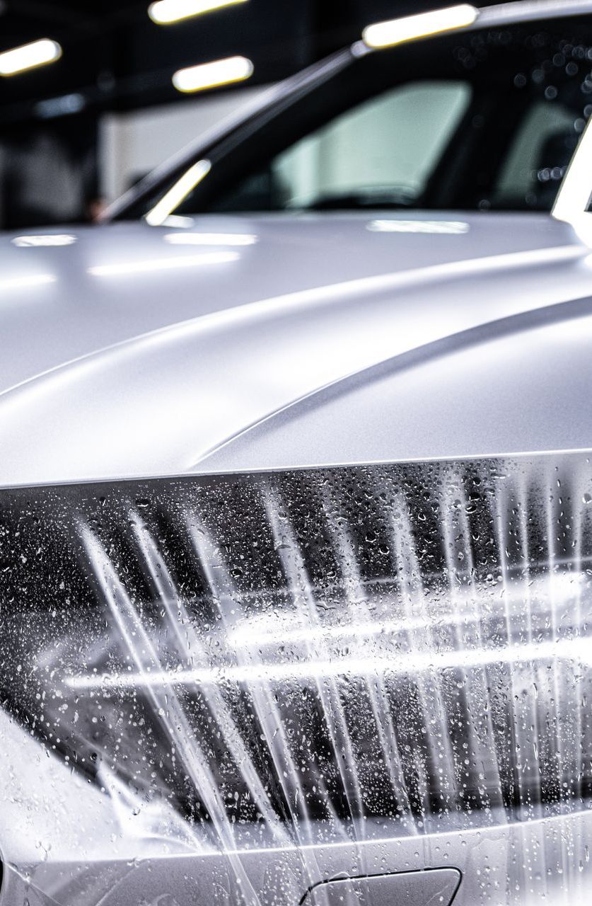A close up of a car being washed with water