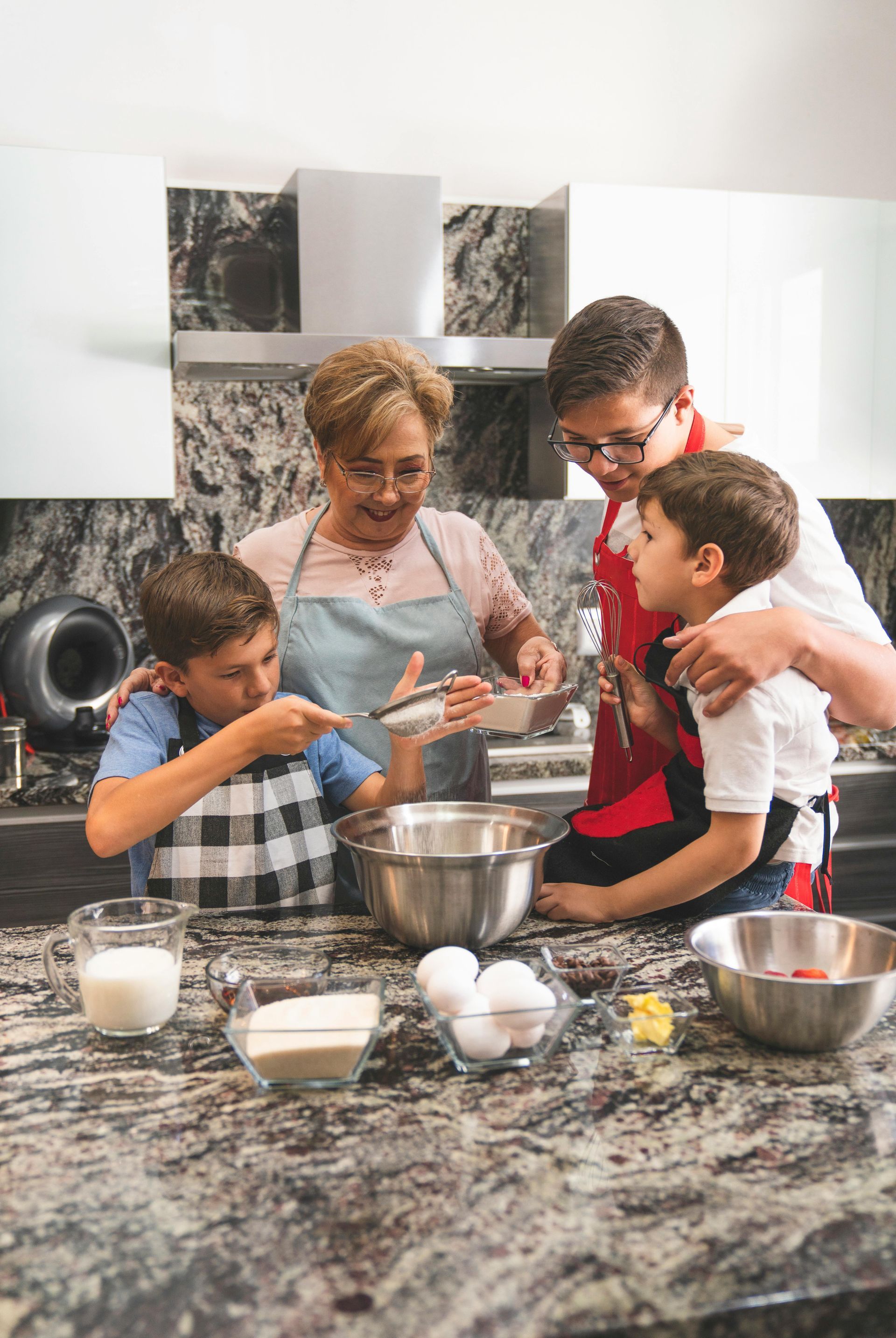 A family is cooking together in a kitchen.