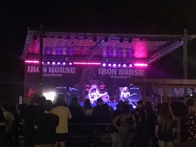 A group of people standing in front of a stage.
