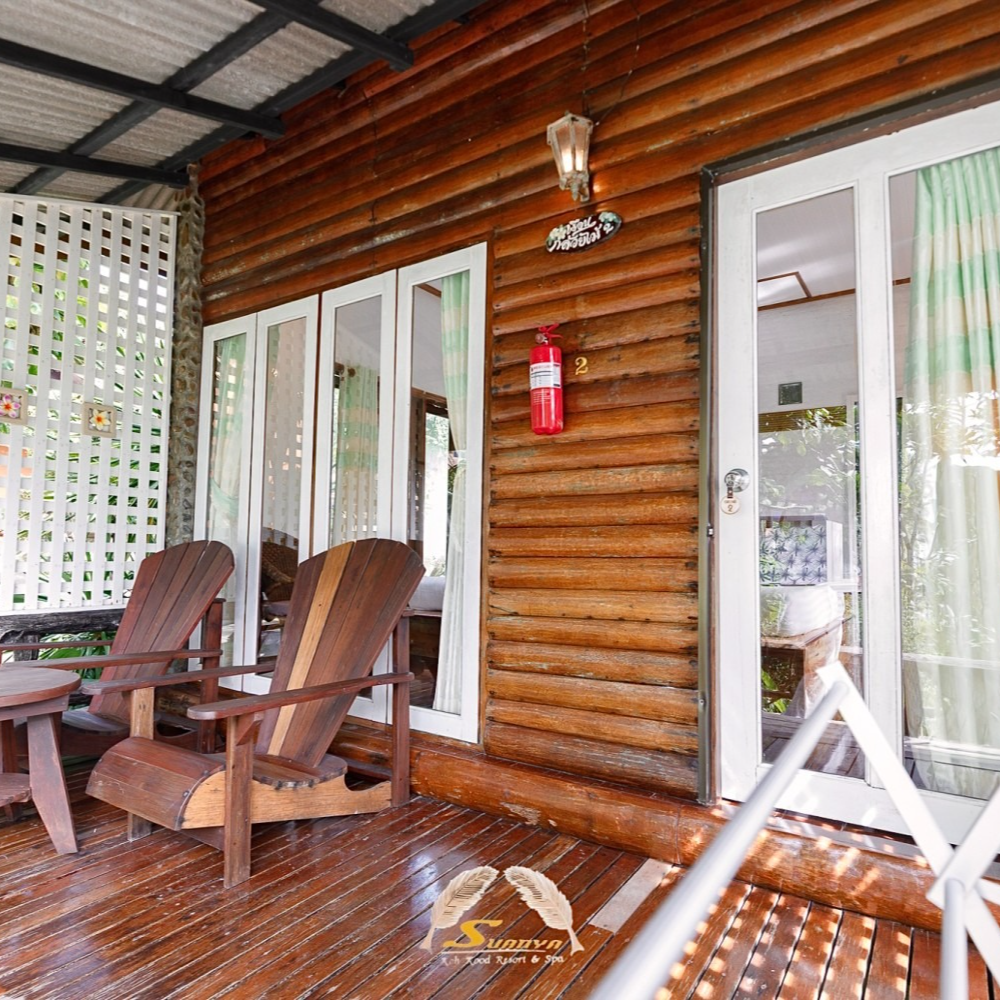 Wooden porch with chairs and sliding glass door. Fire extinguisher on the wood wall.