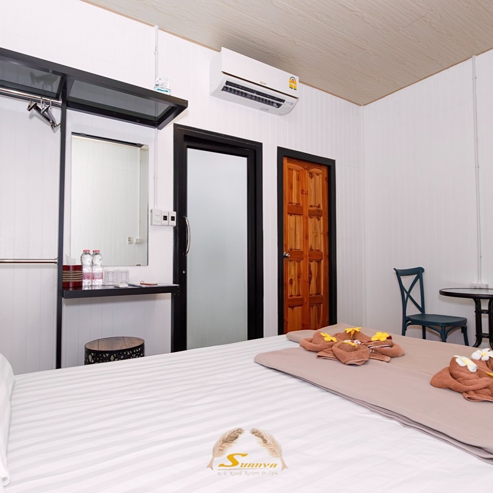 Bedroom with a white bed, doors, mirror, and air conditioner.