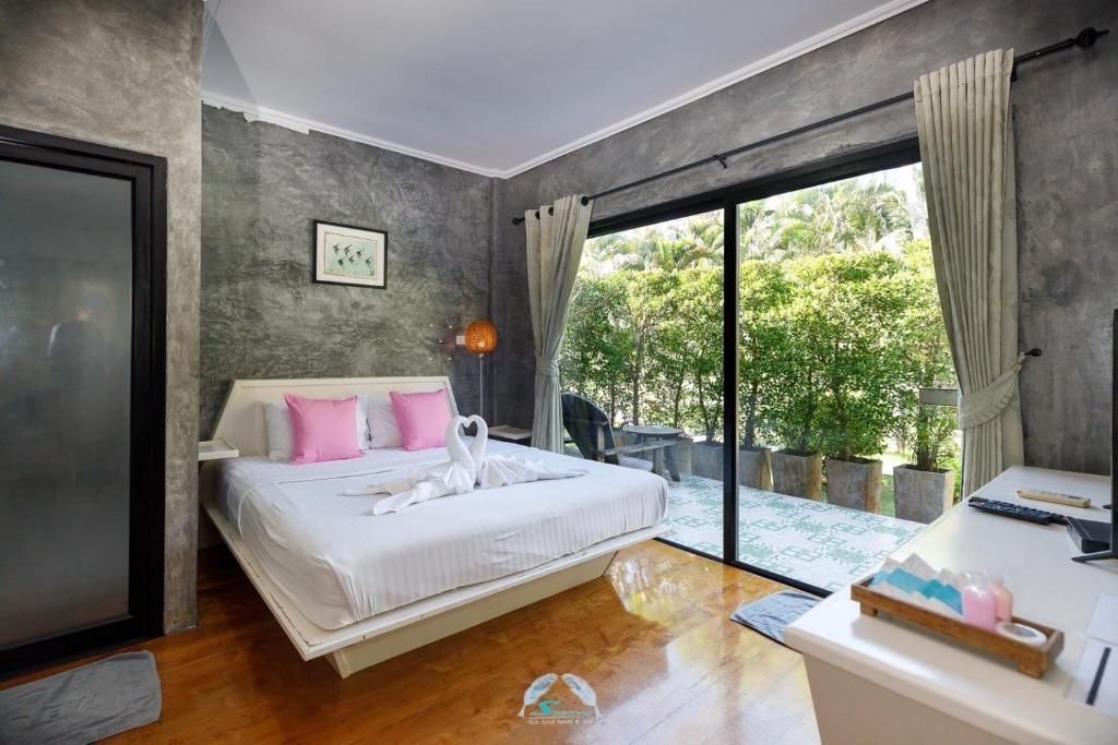 Bedroom with a bed, sliding door to a patio, and gray walls.