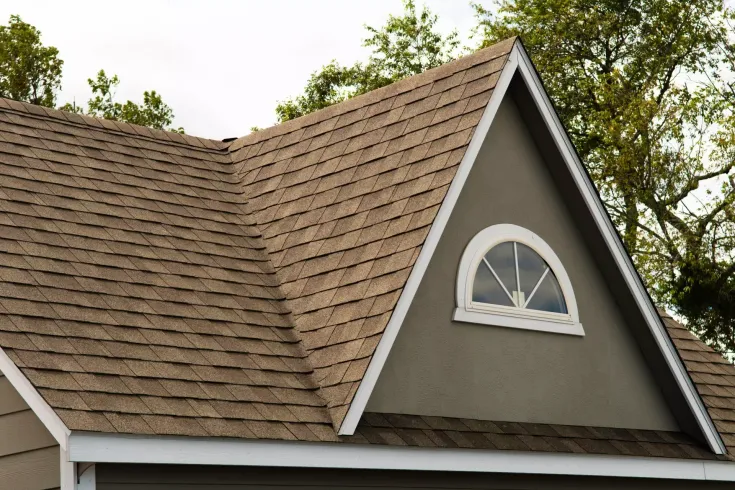 A house with a roof that has a window on it