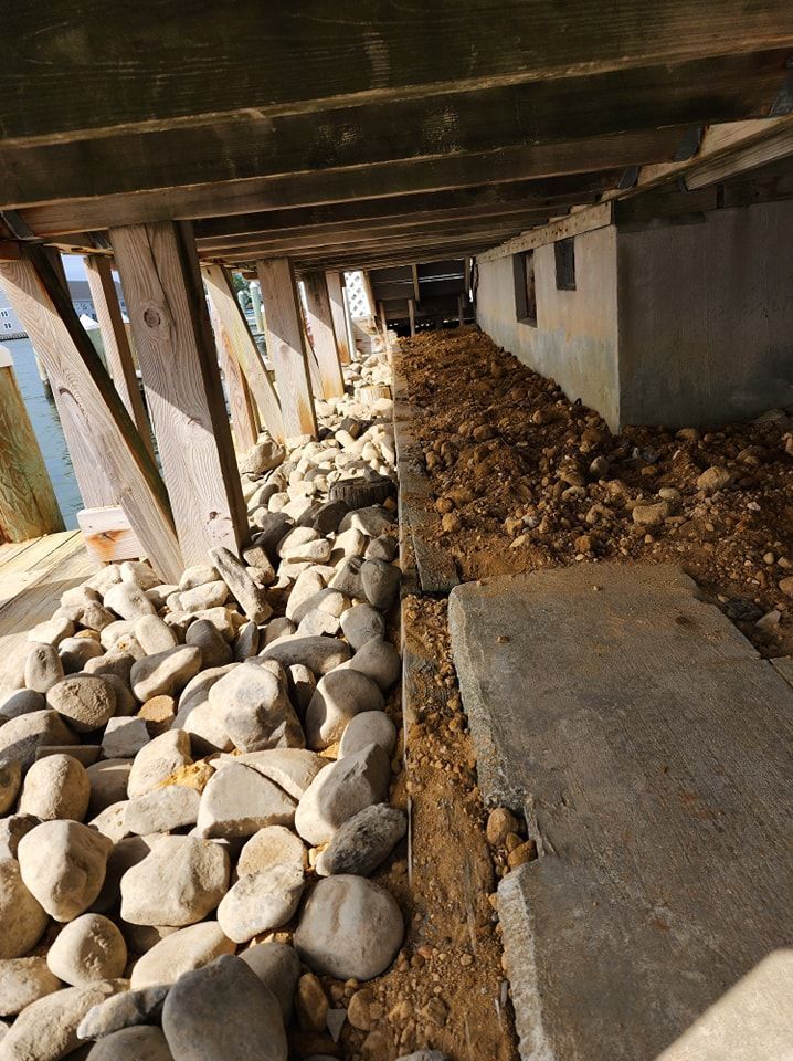 A pile of rocks and dirt under a bridge