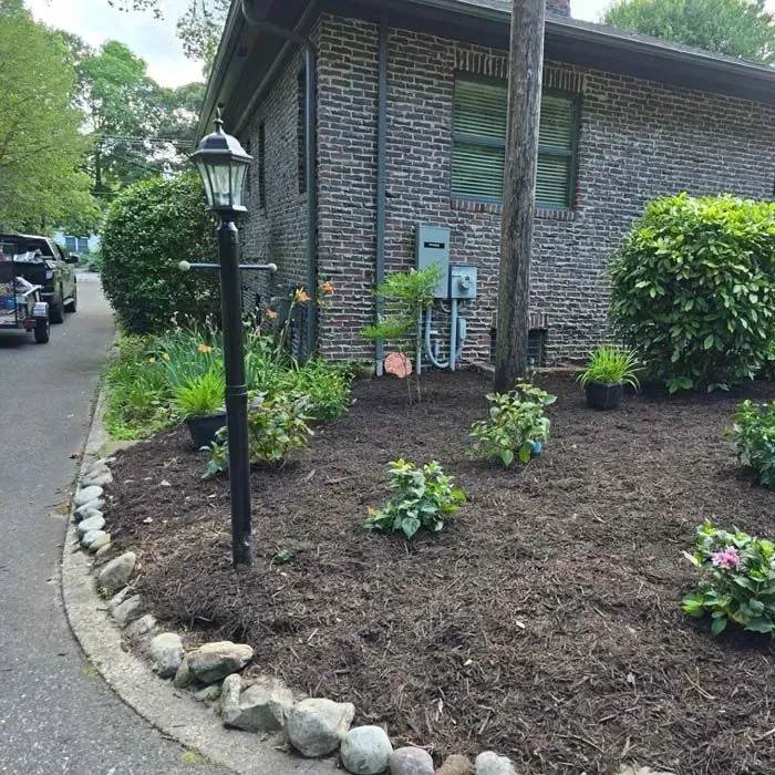 A brick house with a garden in front of it