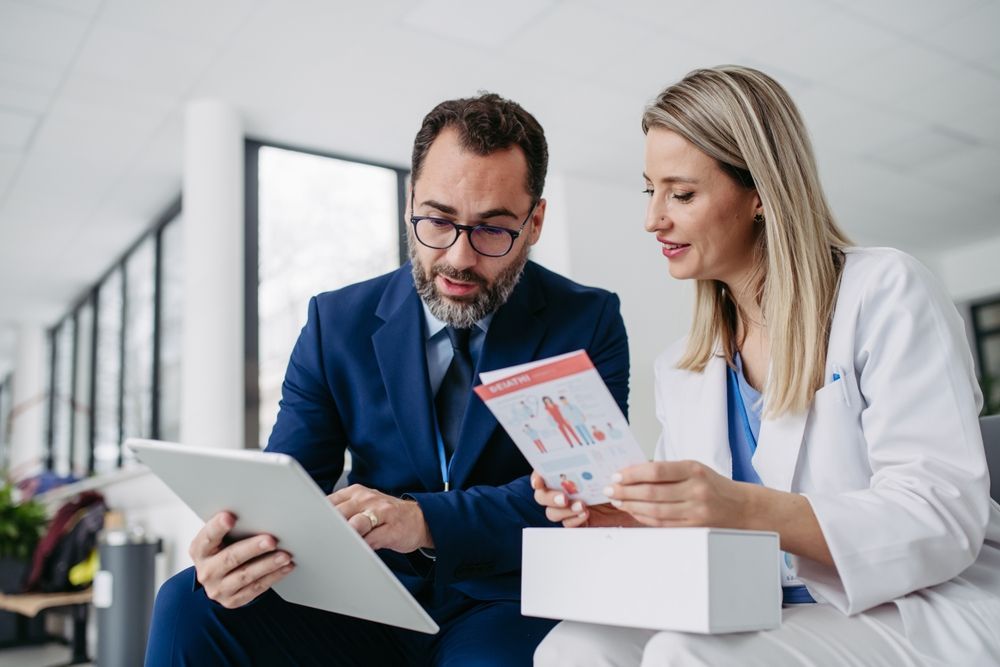 A man and a woman are looking at a tablet together.