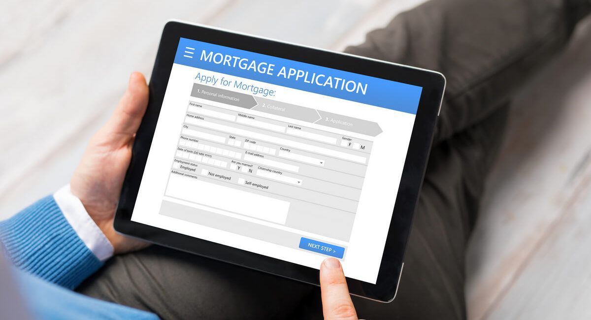 A person is using a tablet computer to fill out a mortgage application.