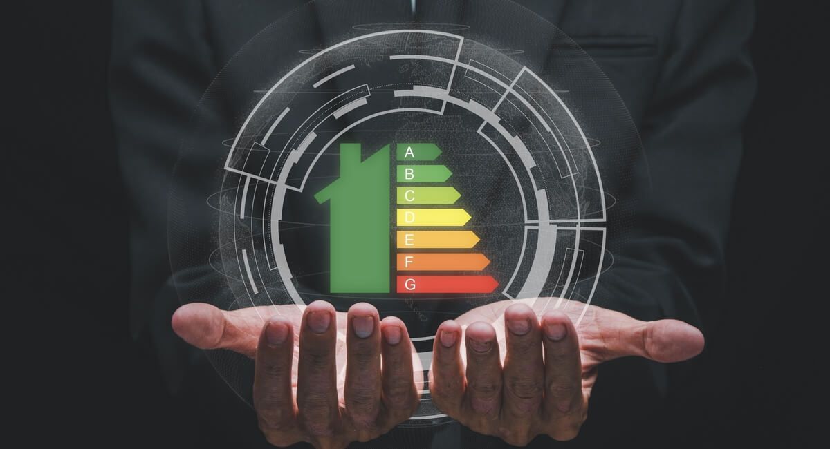 A person is holding a virtual energy efficiency chart in their hands.