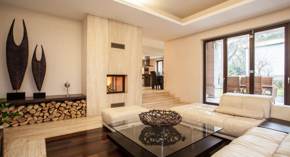 A living room with a couch , coffee table and fireplace.