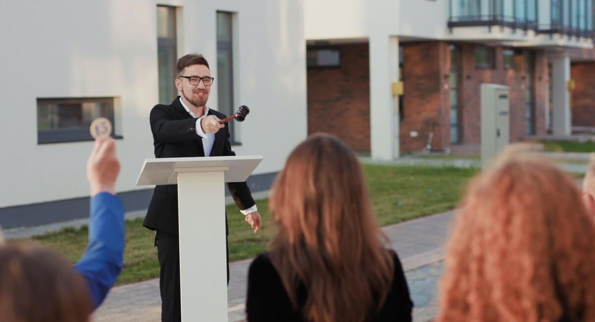 A man is standing at a podium giving a speech to a group of people.