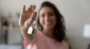 A woman is holding a bunch of keys in her hand.