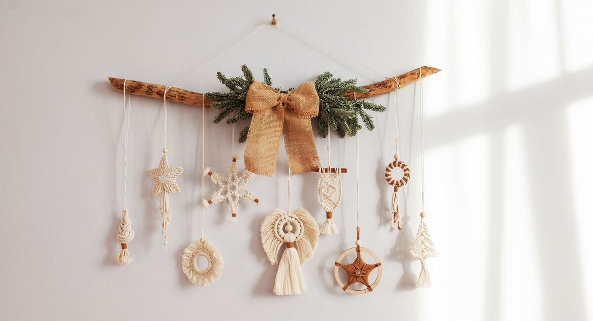 A christmas decoration is hanging on a white wall.