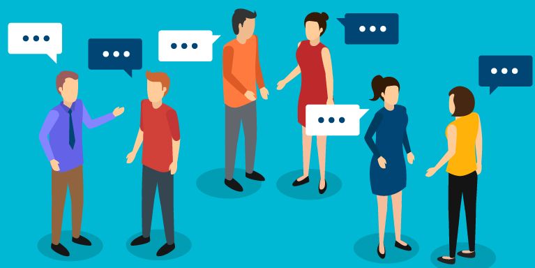 A group of people are standing next to each other and talking.