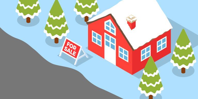 A red house with a for sale sign in front of it surrounded by snow covered trees.