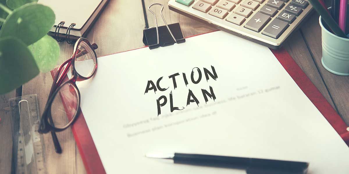 A clipboard with the words `` action plan '' written on it.