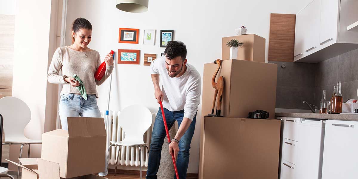 A man and a woman are cleaning their new home.