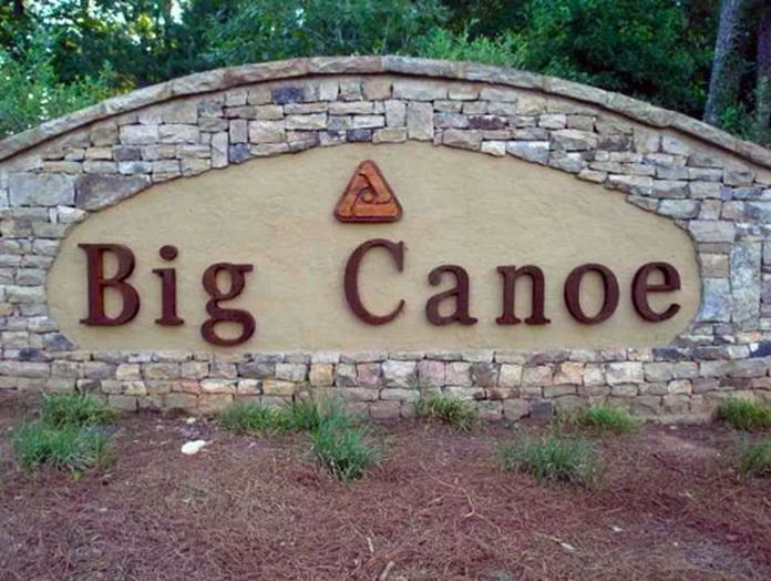 A stone sign that says big canoe on it