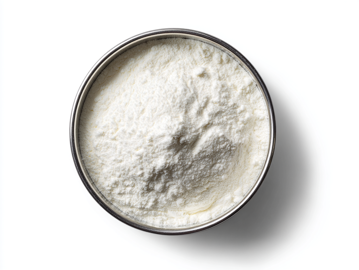 White powder filling a silver bowl, viewed from above, against a white background.