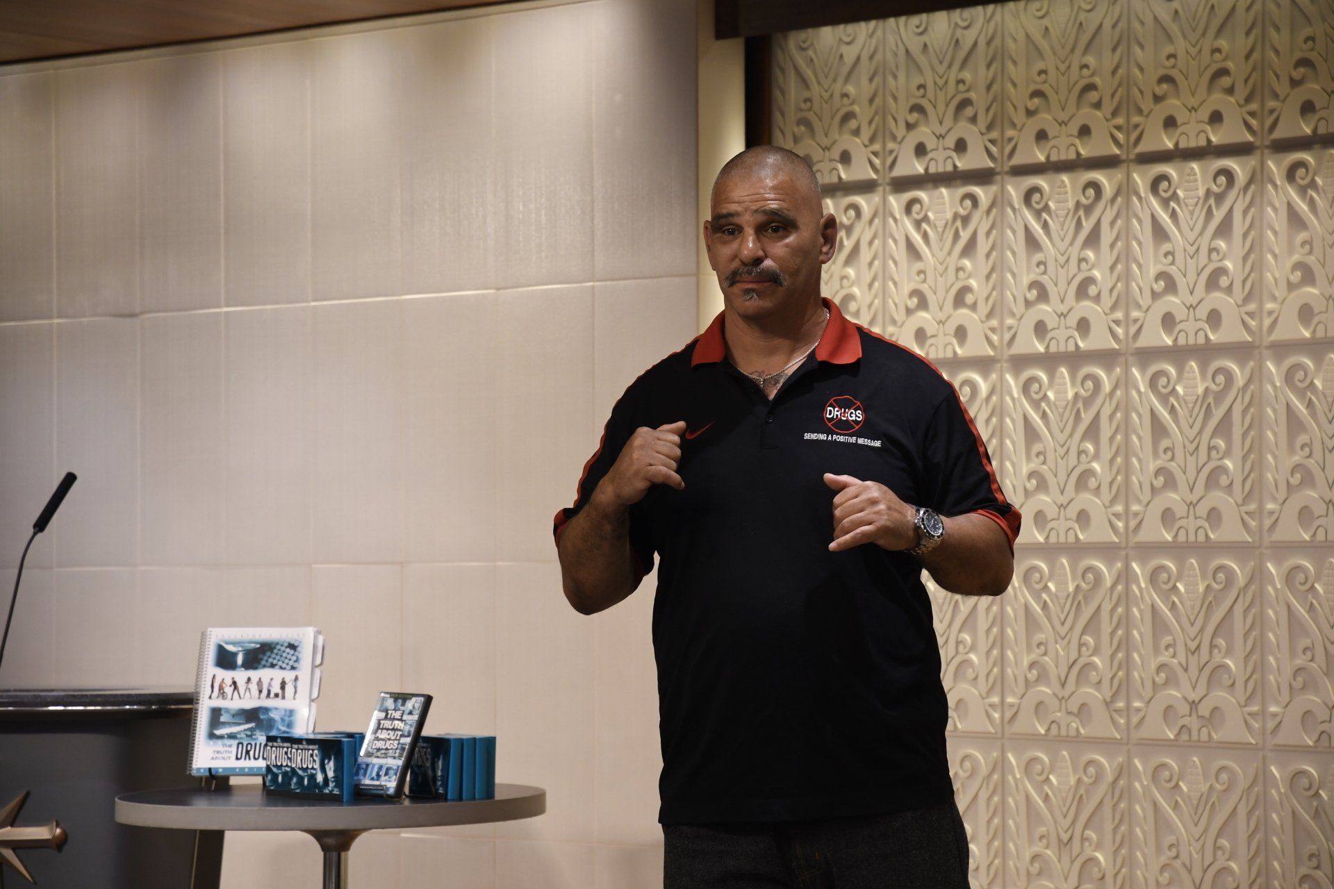 A man is standing in front of a podium giving a presentation.