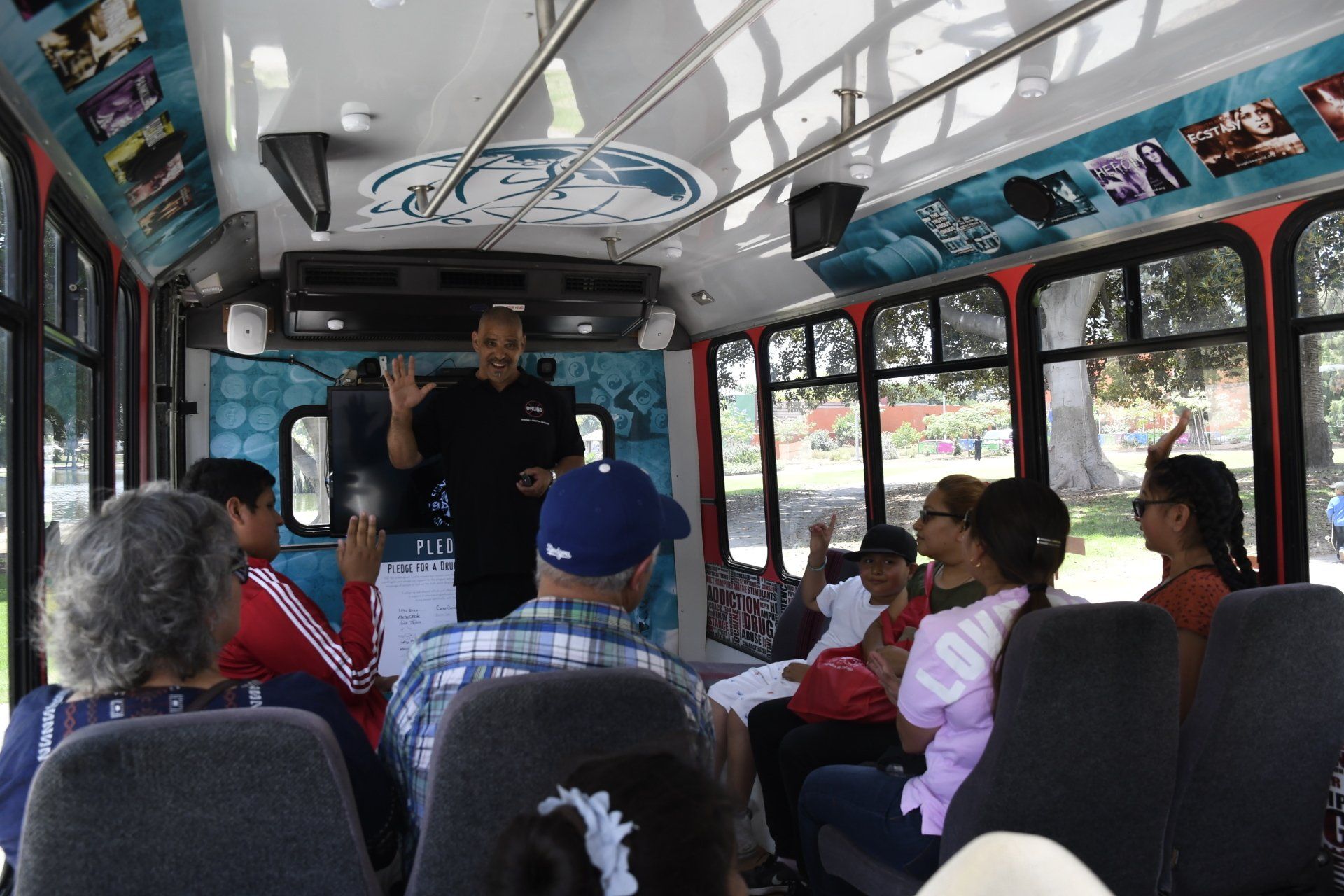 A man is giving a presentation to a group of people on a bus