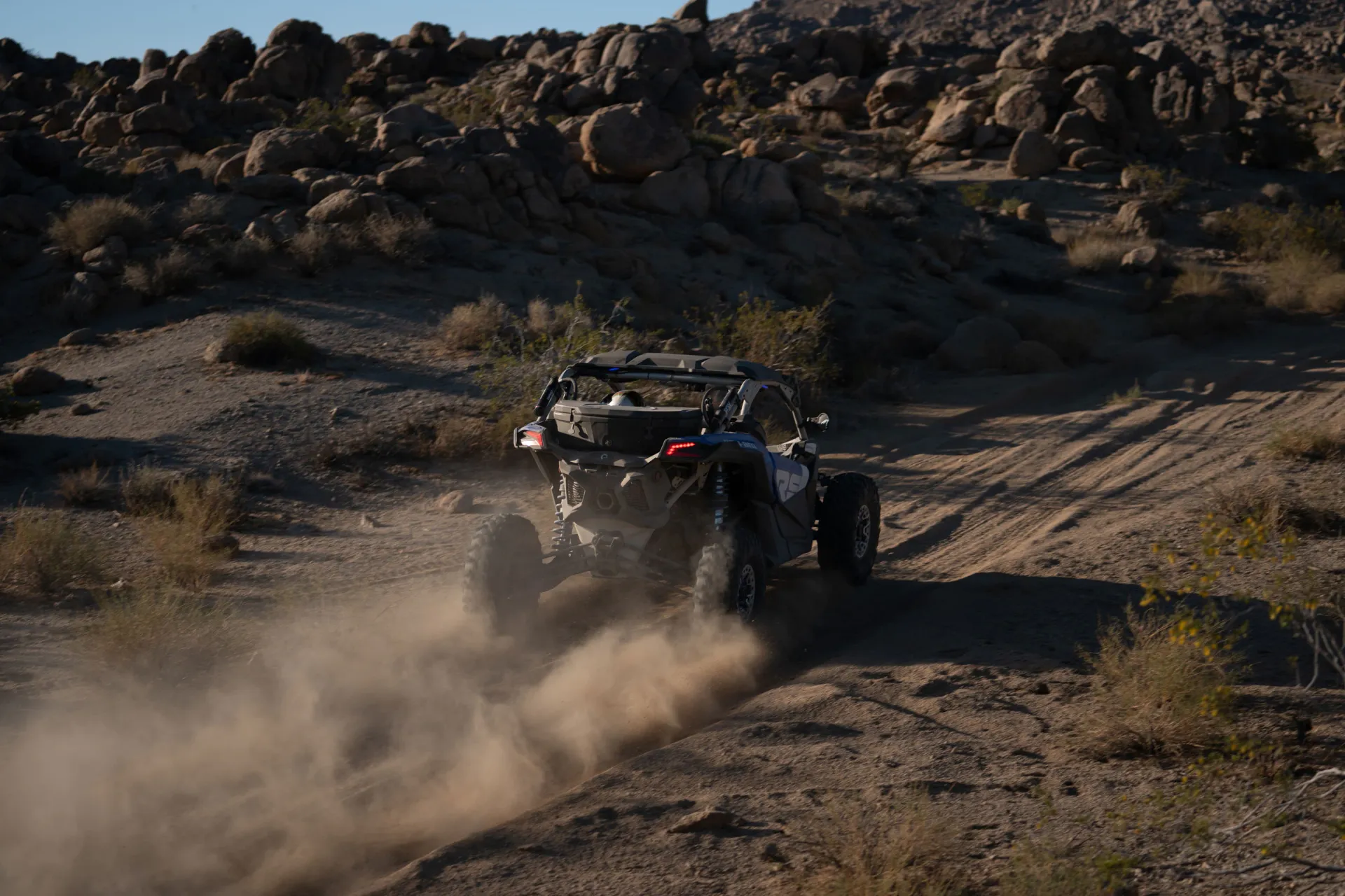 Top back view of Can-Am vehicle on a sandy road