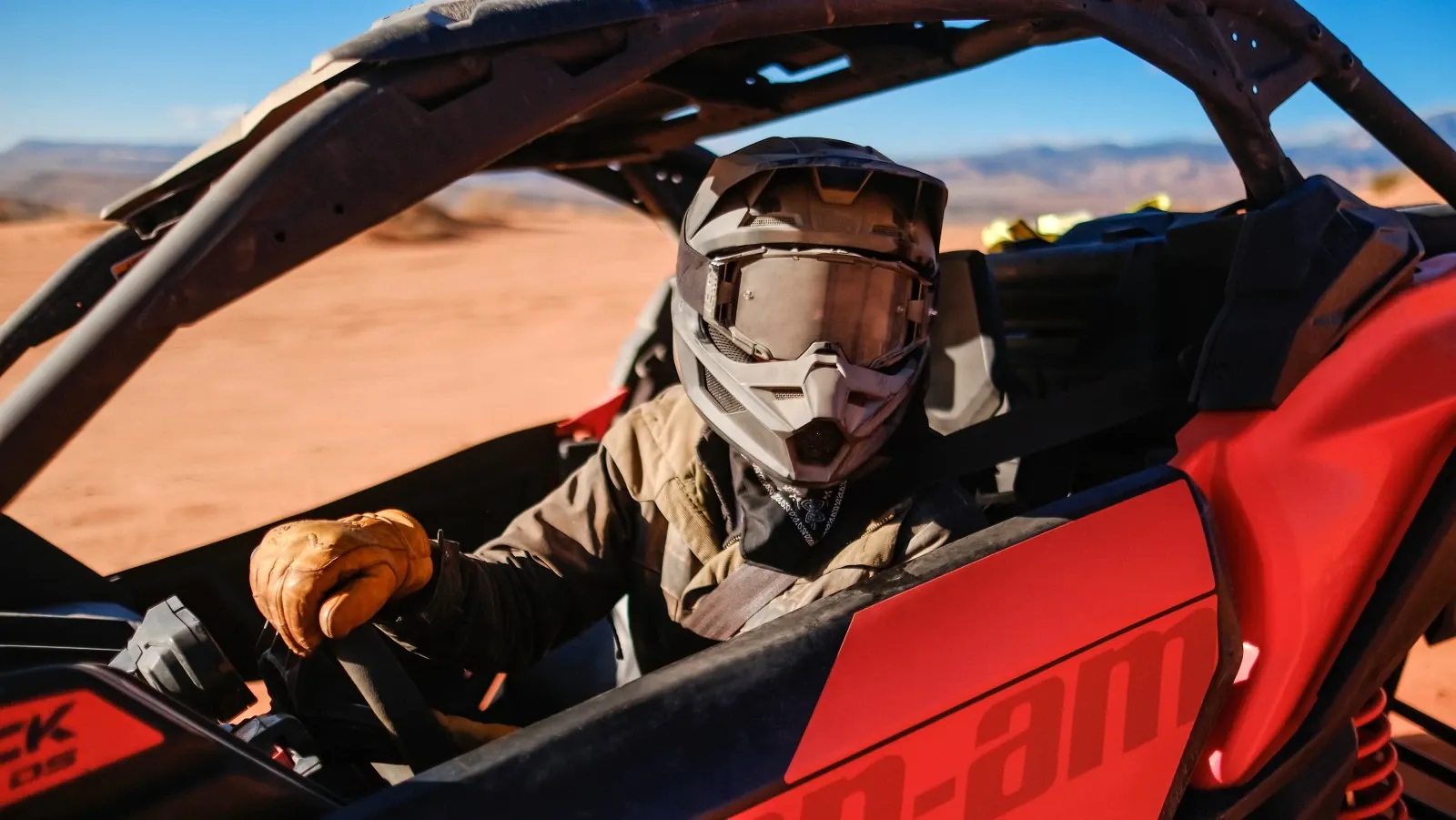 One man driving a red Can-Am vehicle
