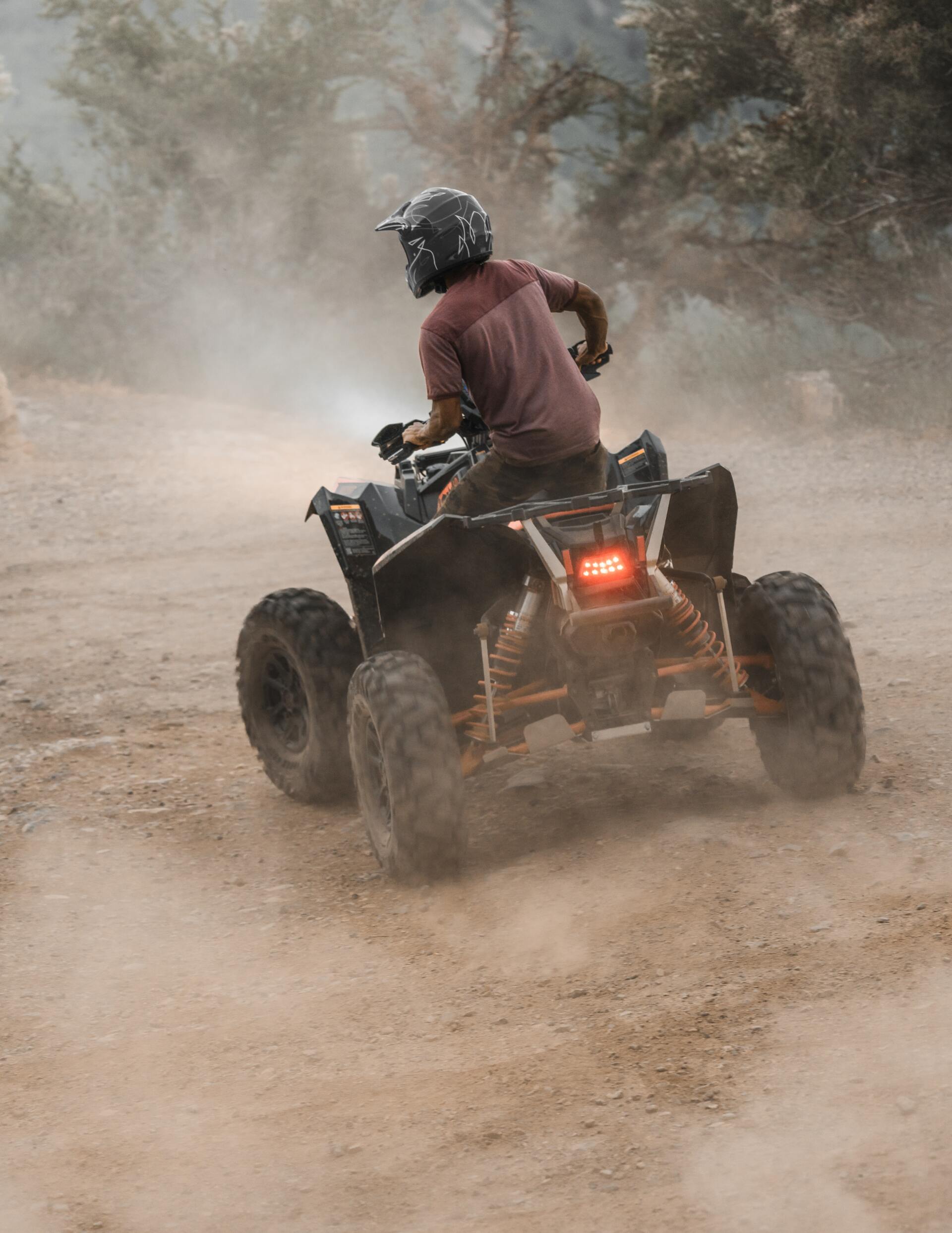 atv four-wheeler ridier in the dirt