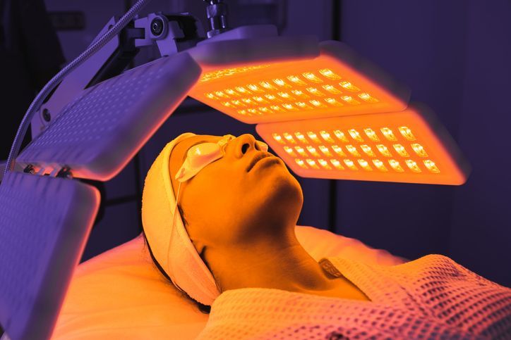 A woman wearing glasses is looking at a machine