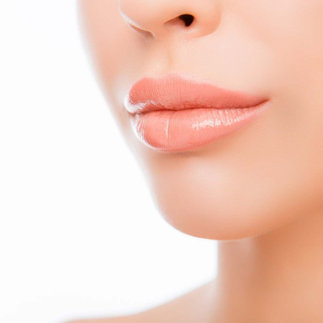 A close up of a woman 's lips and neck on a white background.
