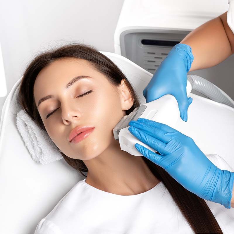 A woman is getting a facial treatment in a beauty salon.