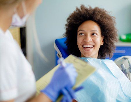 Porcelain Veneers — Woman Having a Consultation with a Dentist in Hoover, AL