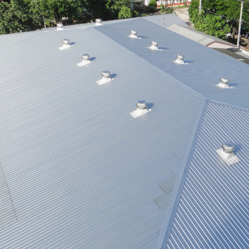 A large metal roof with a lot of vents on it