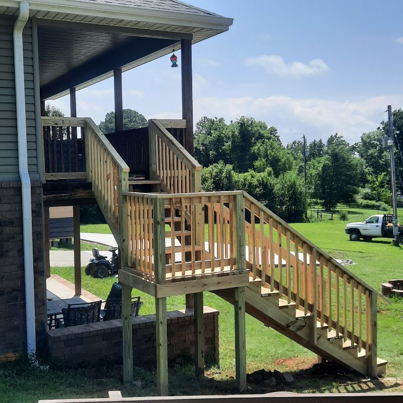 A wooden deck with stairs leading up to it