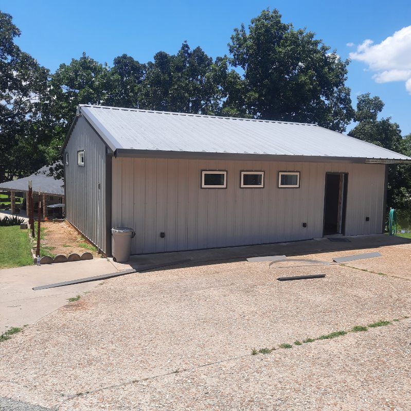 A small house with a white roof and three windows