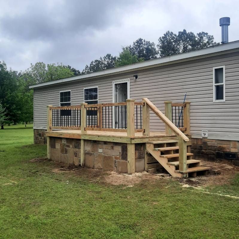 A house with a wooden deck and stairs in front of it