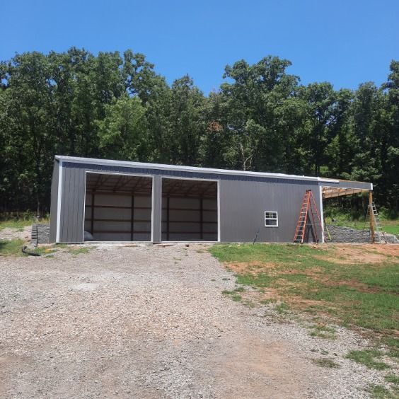 A gray building with a ladder in front of it