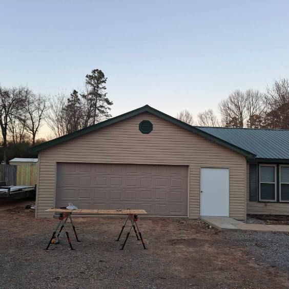 A house with a garage and a table in front of it