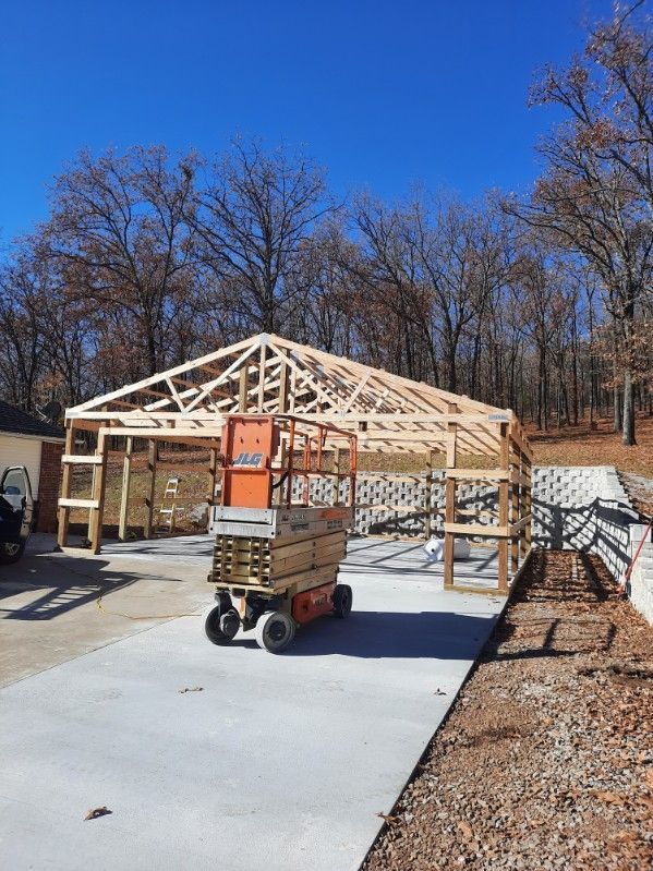 A crane is sitting in front of a building under construction.