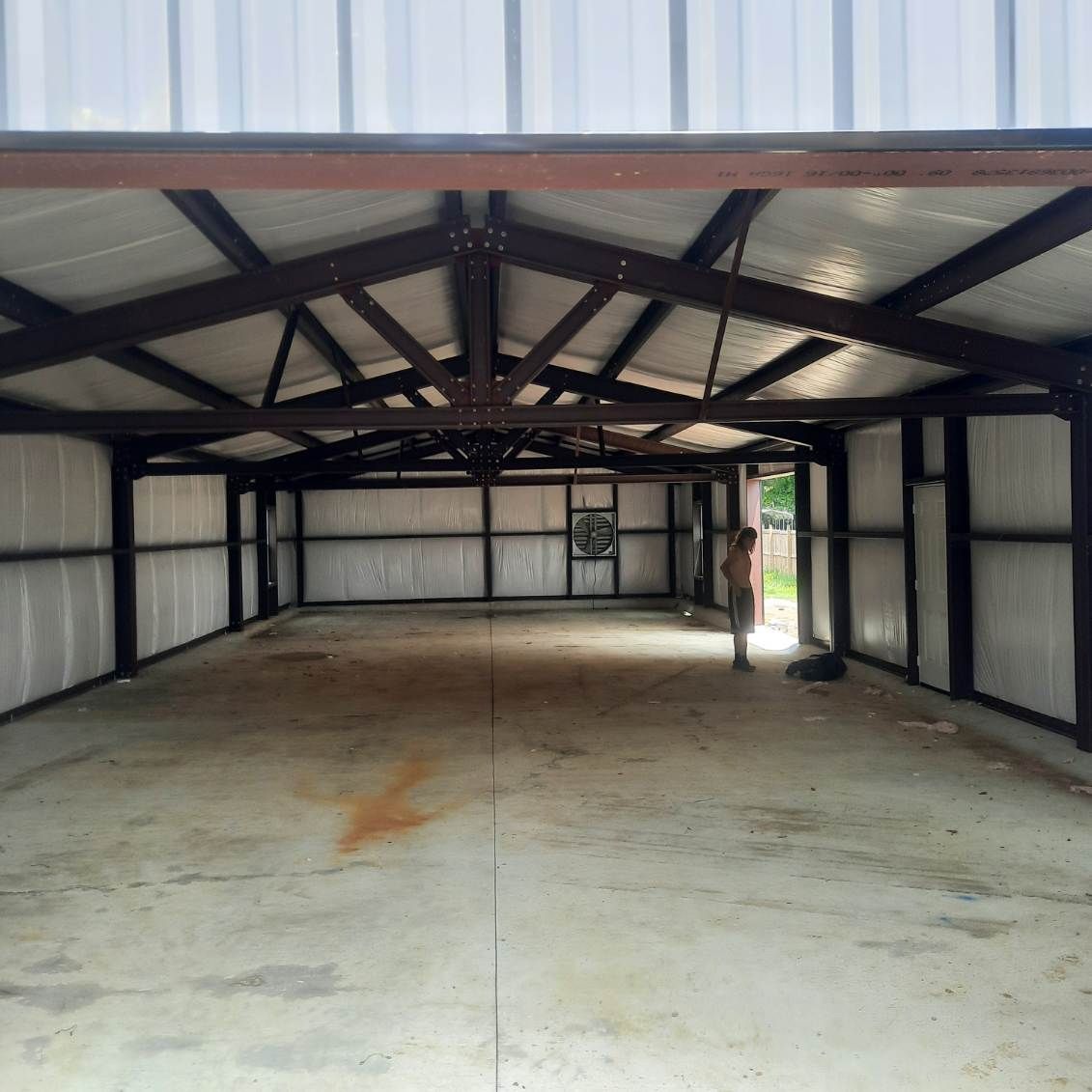 A large empty building with a metal roof