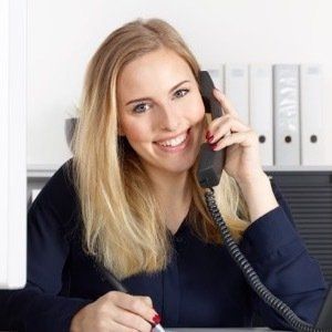 professional female on phone in front of computer